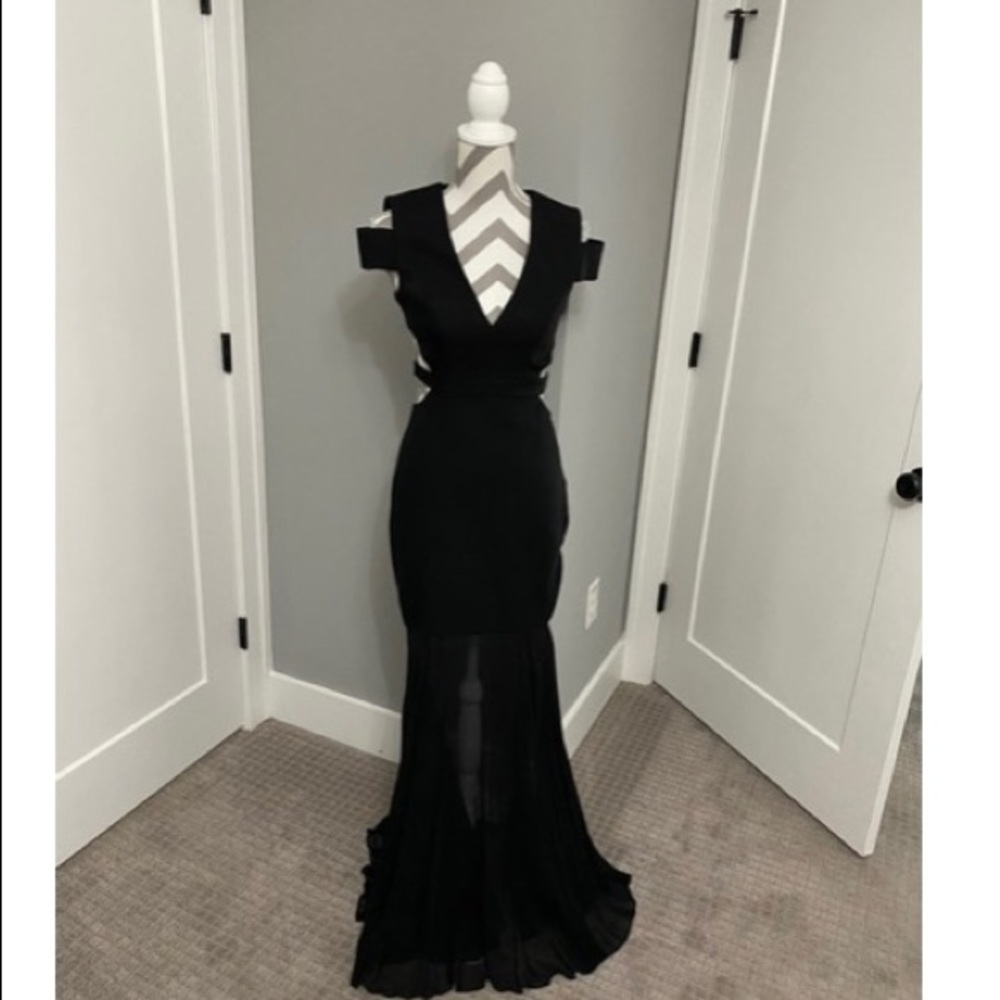 Black formal dress, sheer like martial starts right above the knees. Backless